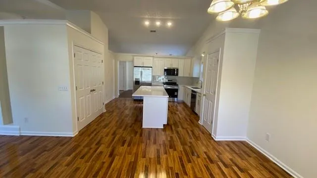 a kitchen with stainless steel appliances a refrigerator and a stove top oven