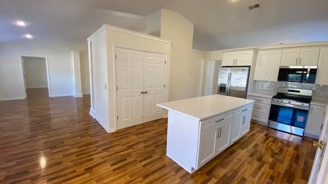 a kitchen with sink cabinets and wooden floor