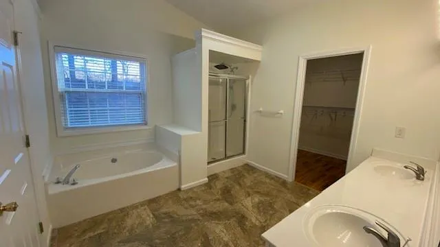 a view of a livingroom with wooden floor and a mirror