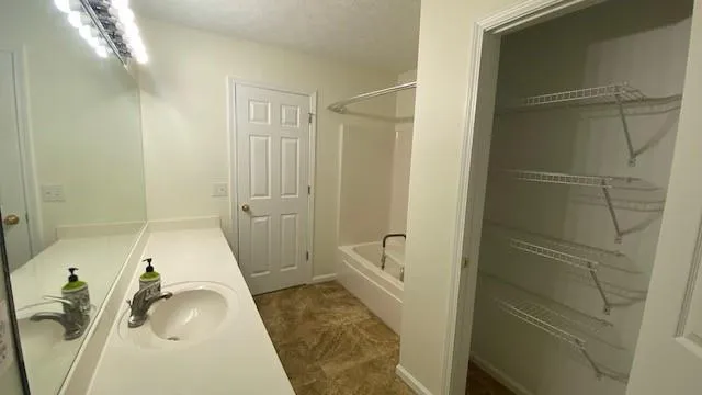 a view of a hallway with wooden floor and entryway