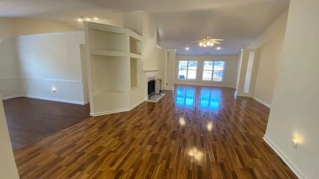 a view of a room with wooden floor and window