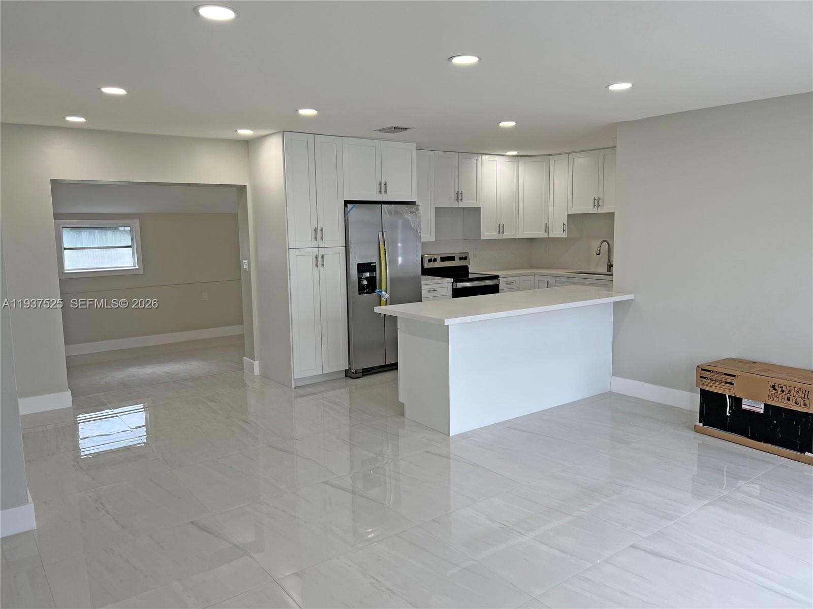 11962 Southwest 37th Terrace Miami, FL 33175 - Photo 4 of 24 a kitchen with stainless steel appliances kitchen island granite countertop a refrigerator a stove and a sink