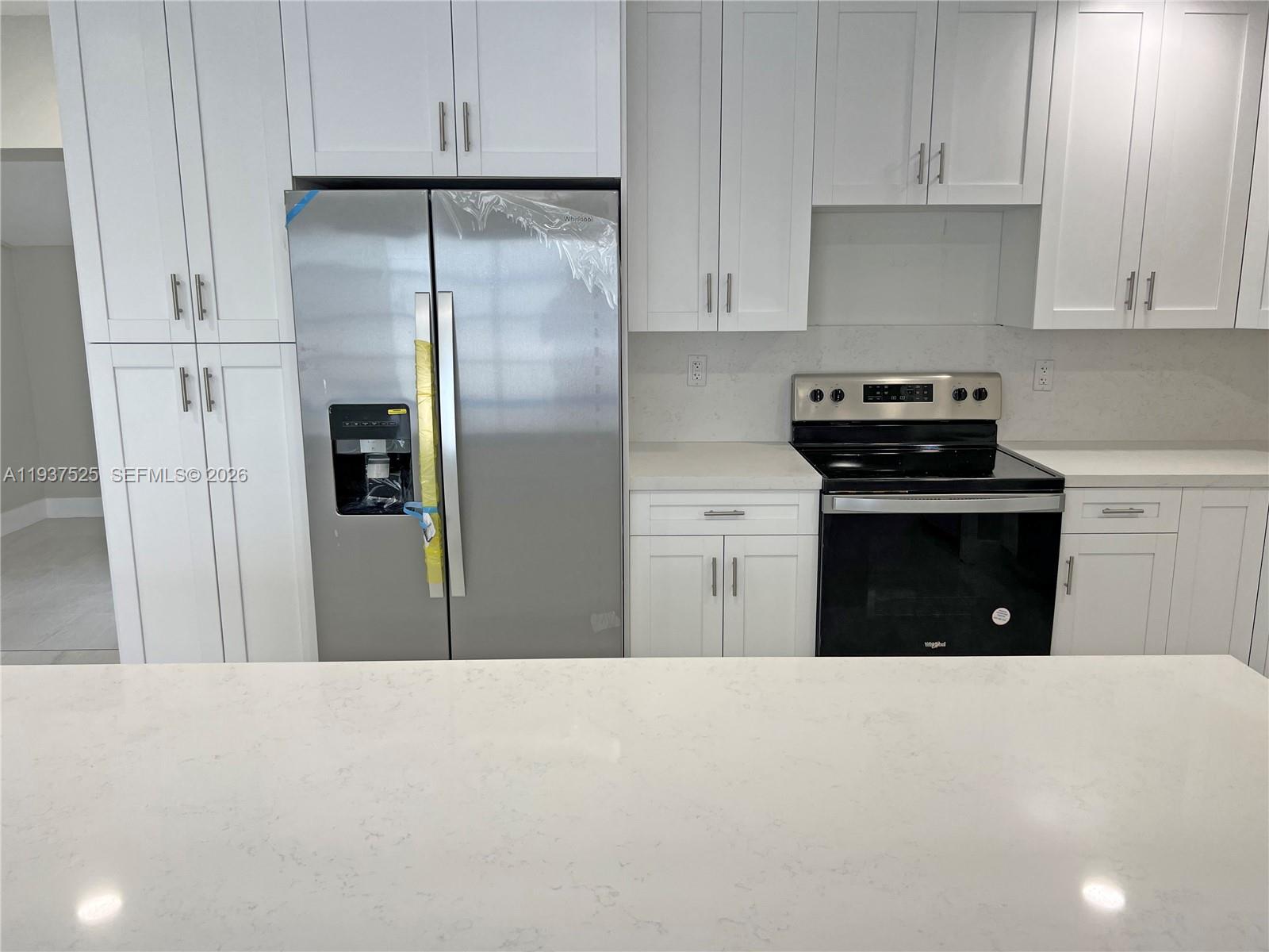11962 Southwest 37th Terrace Miami, FL 33175 - Photo 6 of 24 a kitchen with stainless steel appliances a refrigerator stove and cabinets