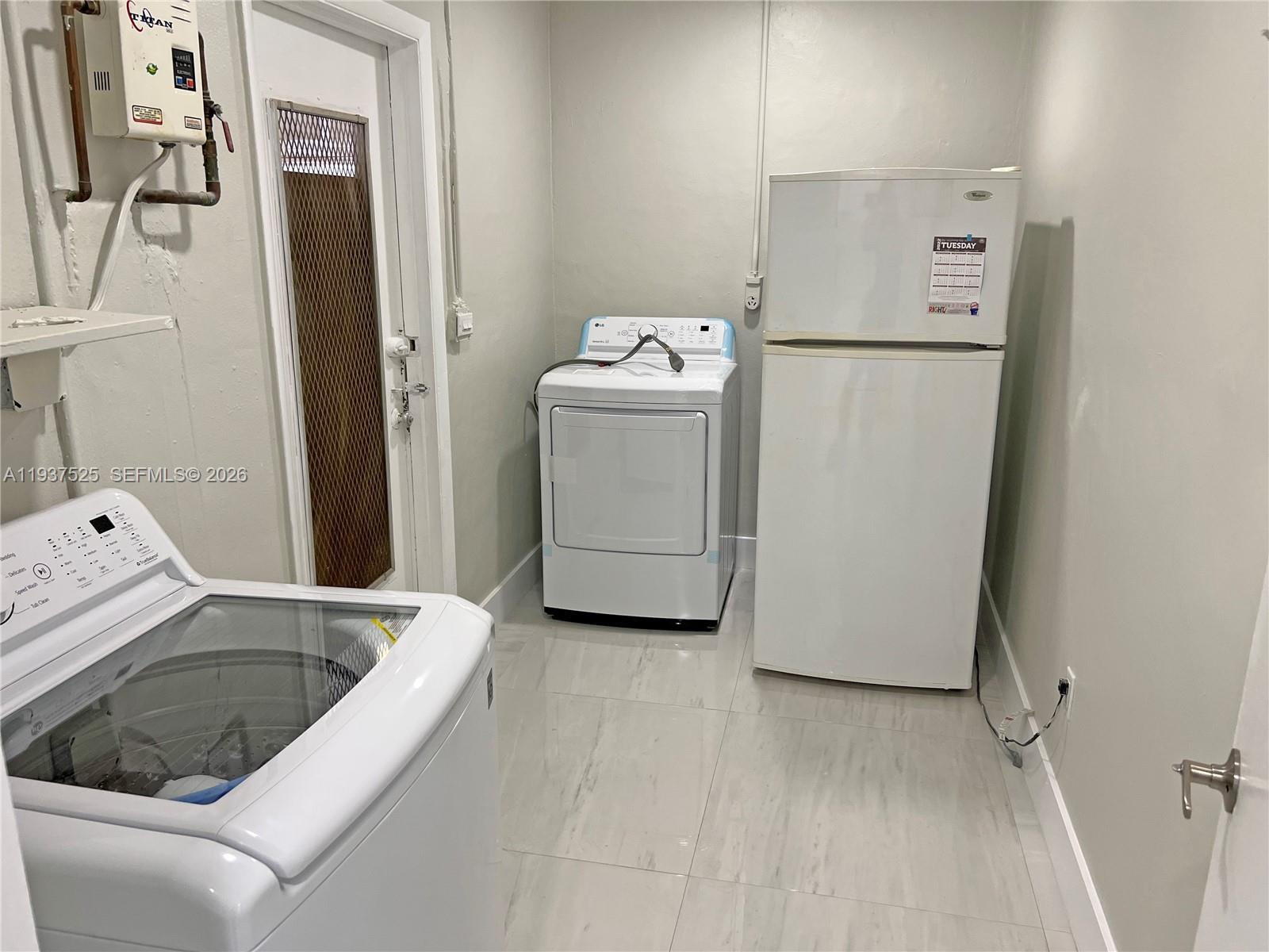 11962 Southwest 37th Terrace Miami, FL 33175 - Photo 10 of 24 a utility room with dryer and washer