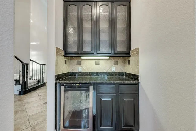 a kitchen with a refrigerator and cabinets