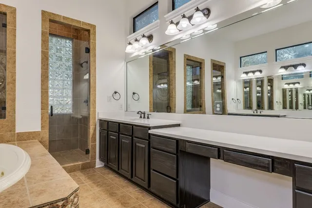 a spacious bathroom with a double vanity sink mirror and double