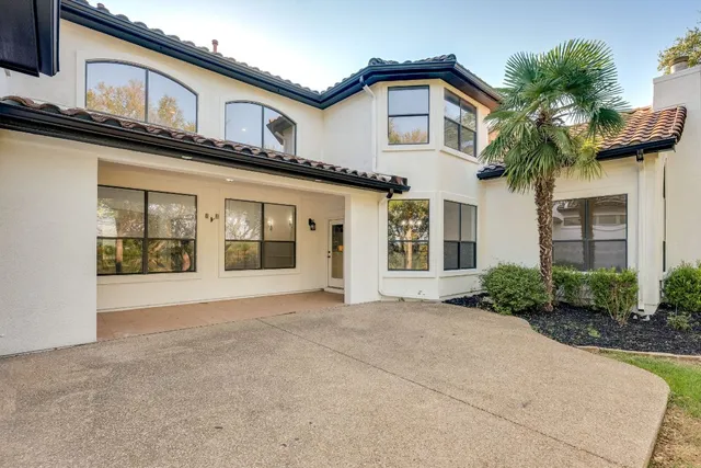 a front view of a house with a garden and garage