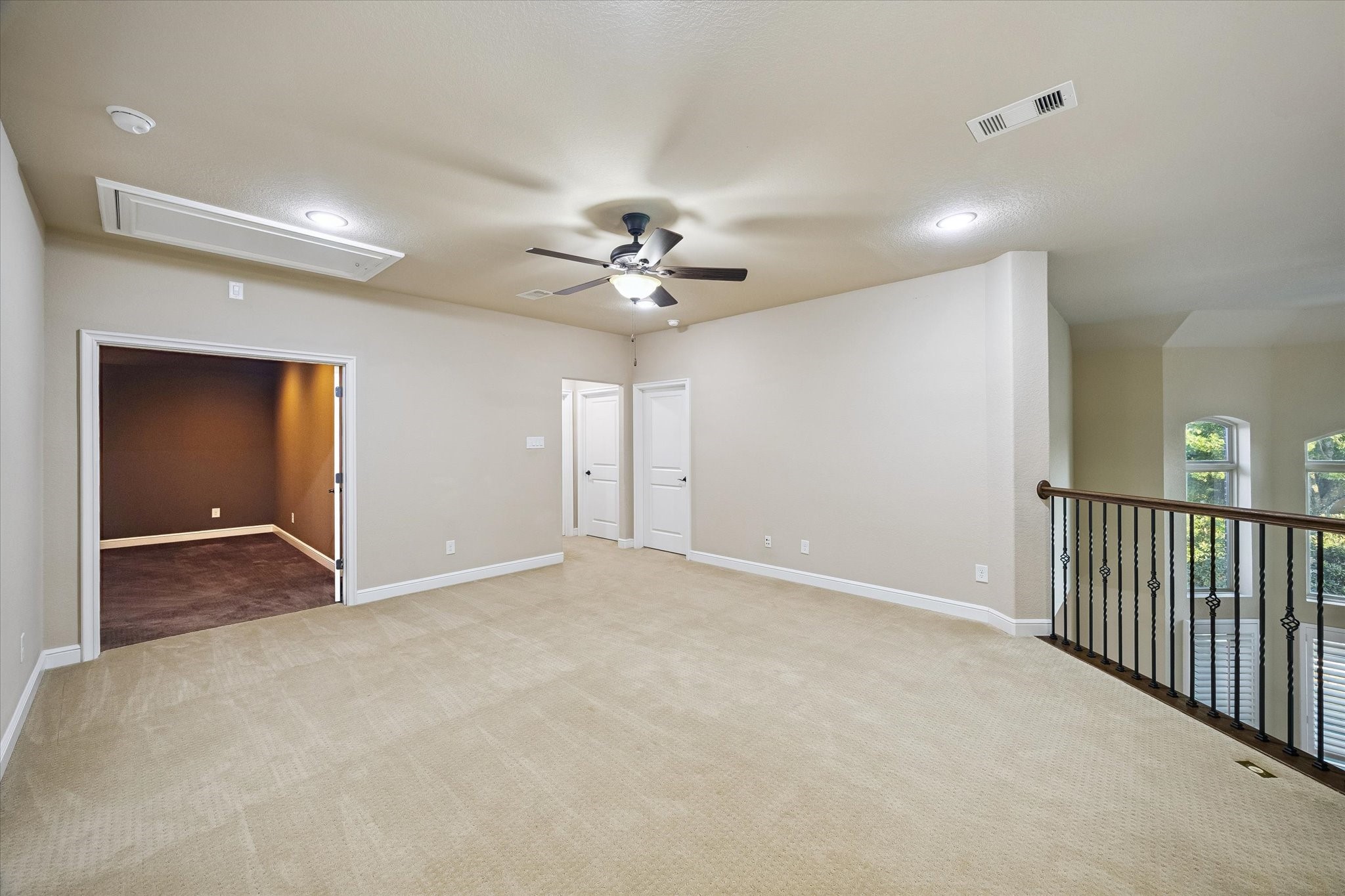 35 North Fremont Ridge Loop Spring, TX 77389 - Photo 21 of 37 e upstairs gathering area serves as a natural extension of the home's living spaces, featuring an elegant iron-railed overlook that offers sweeping views of the dramatic two-story family room below. This thoughtful design creates a sense of openness while keeping family and guests connected across both levels.
