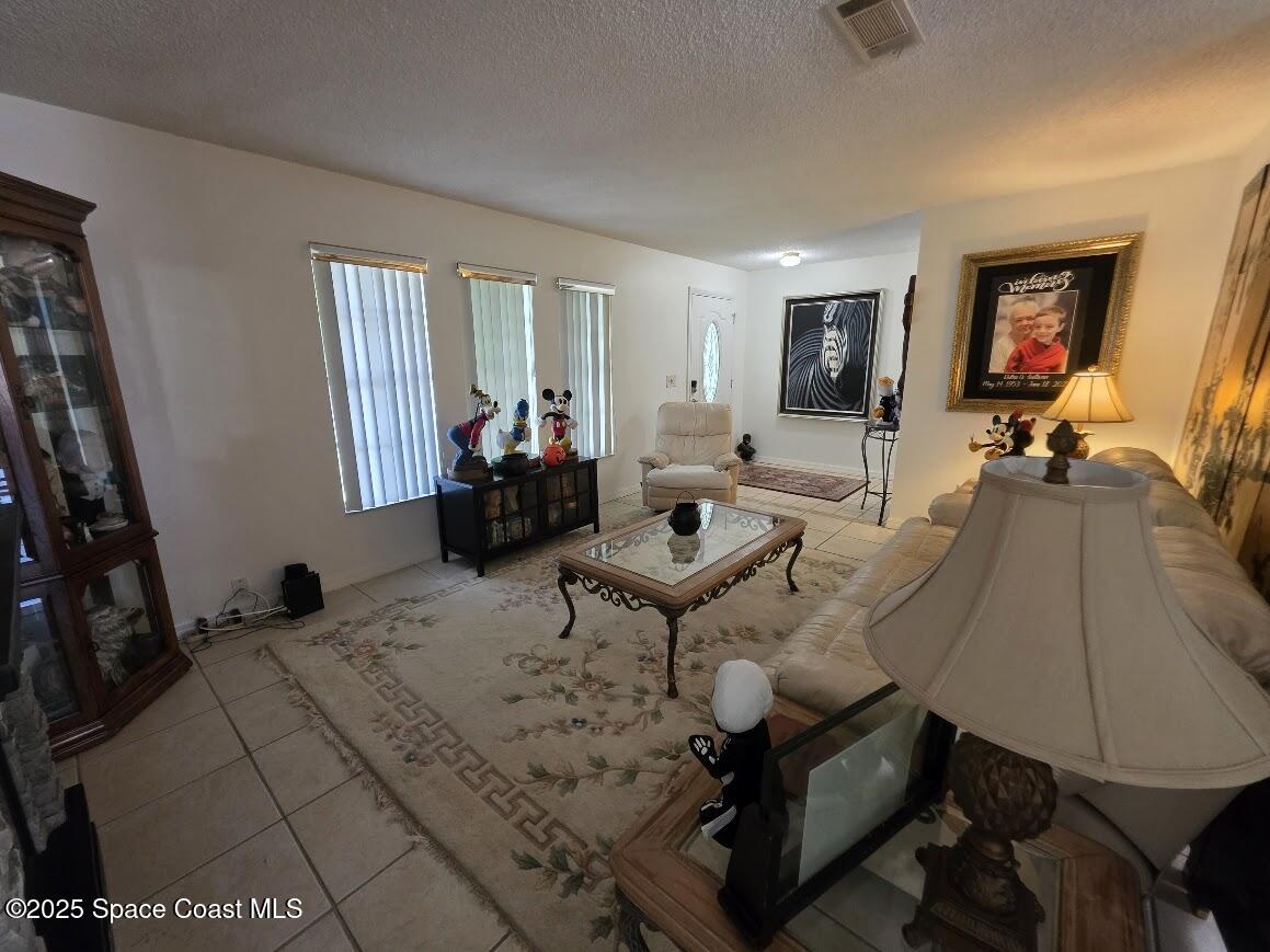 250 Perth Avenue Merritt Island, FL 32953 - Photo 14 of 48 a living room with furniture a window and a flat screen tv