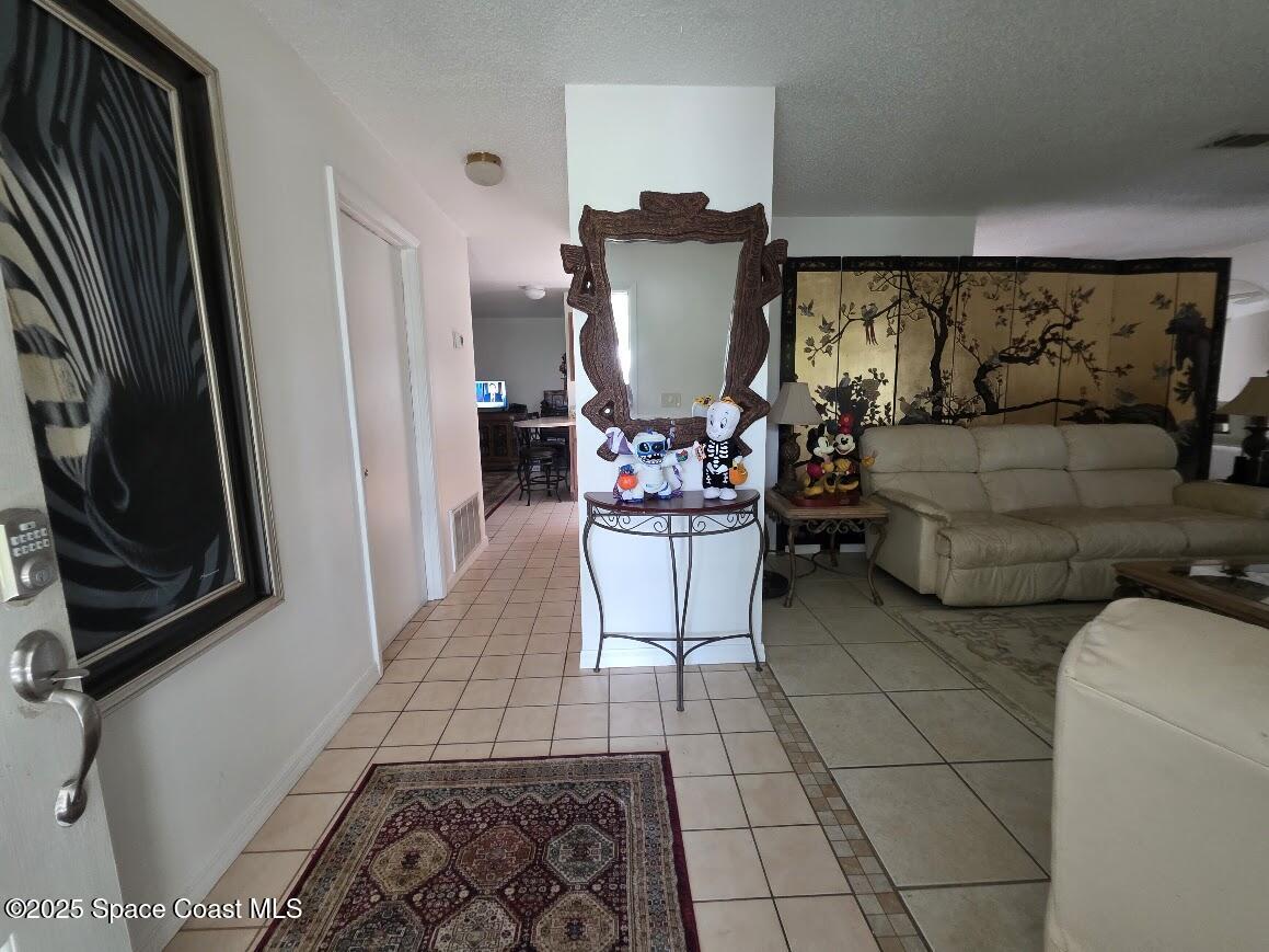 250 Perth Avenue Merritt Island, FL 32953 - Photo 15 of 48 a living room with furniture and a flat screen tv