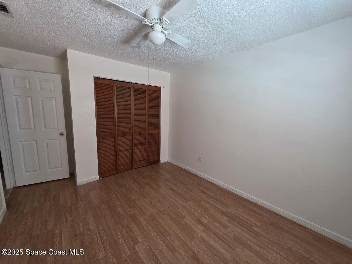 250 Perth Avenue Merritt Island, FL 32953 - Photo 17 of 48 a view of an empty room with wooden floor