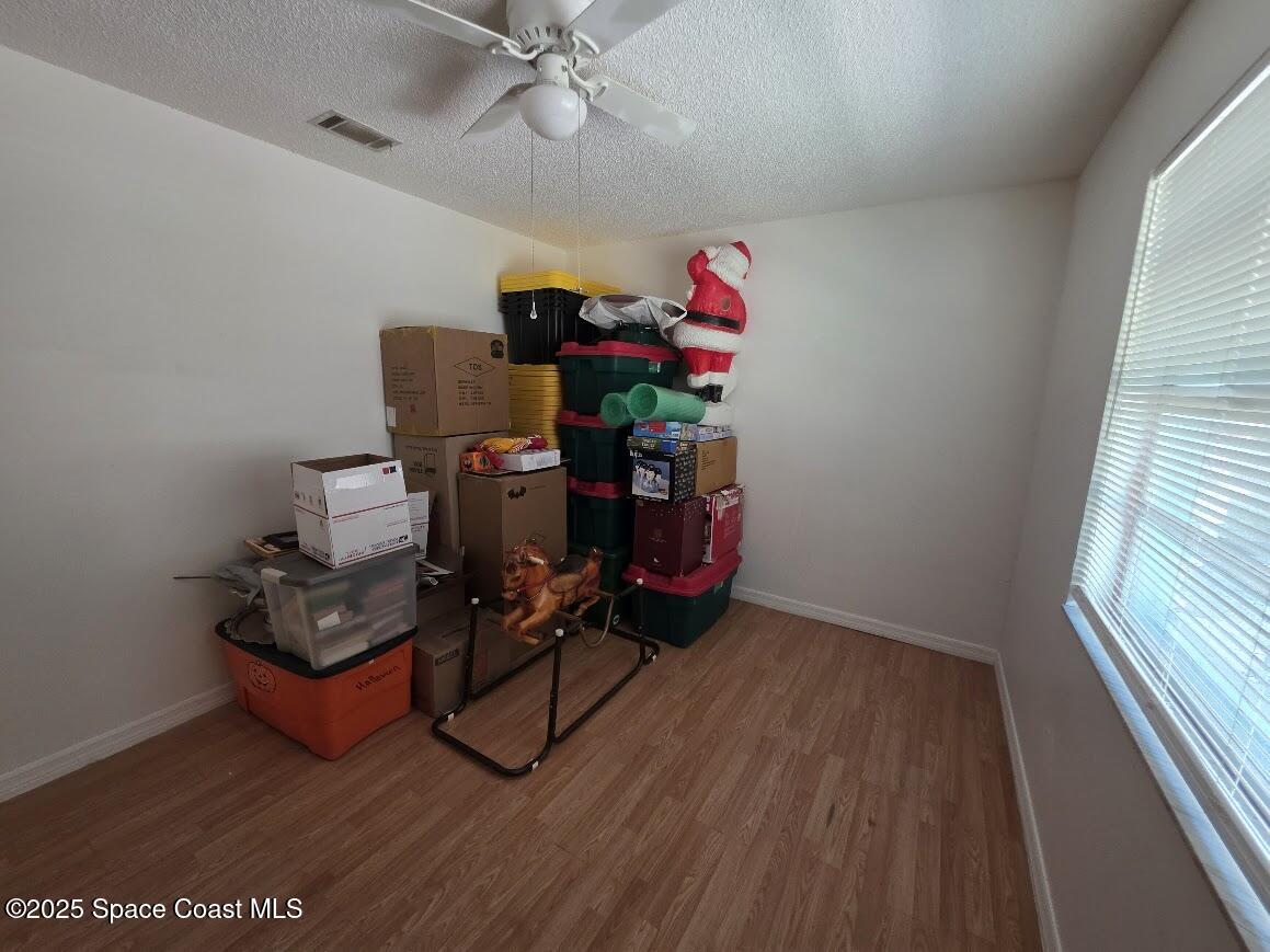 250 Perth Avenue Merritt Island, FL 32953 - Photo 19 of 48 a room with furniture and wooden floor