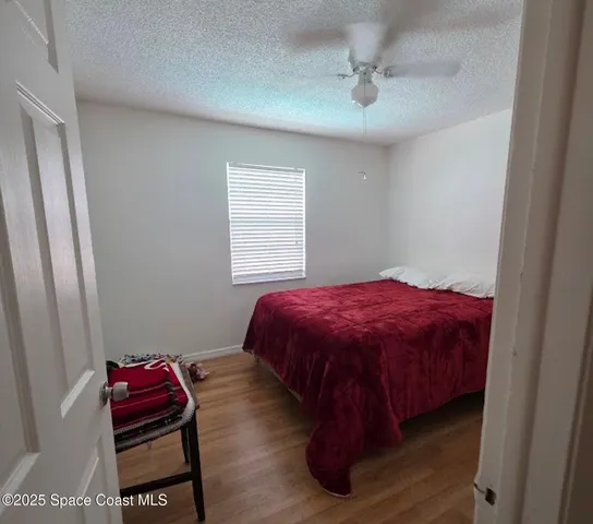 a bedroom with a bed and a chair