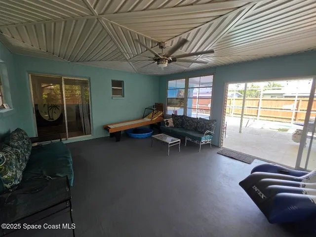 a living room with furniture and a pool table