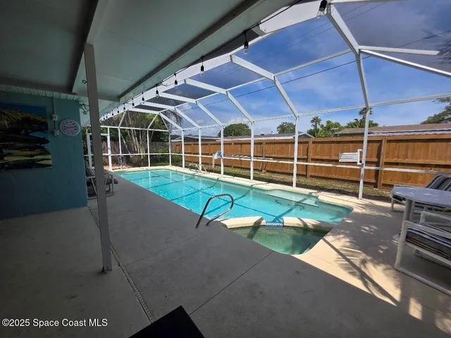 a view of a house with backyard and sitting area