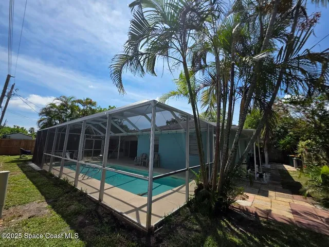 a house with green field in front of it