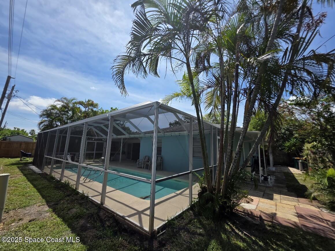 250 Perth Avenue Merritt Island, FL 32953 - Photo 40 of 48 a view of a backyard with a small deck and a garden