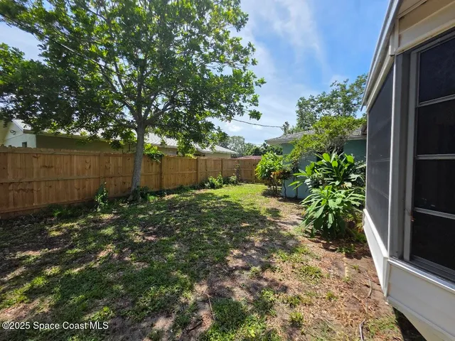 a view of a patio with table and chairs under an umbrella