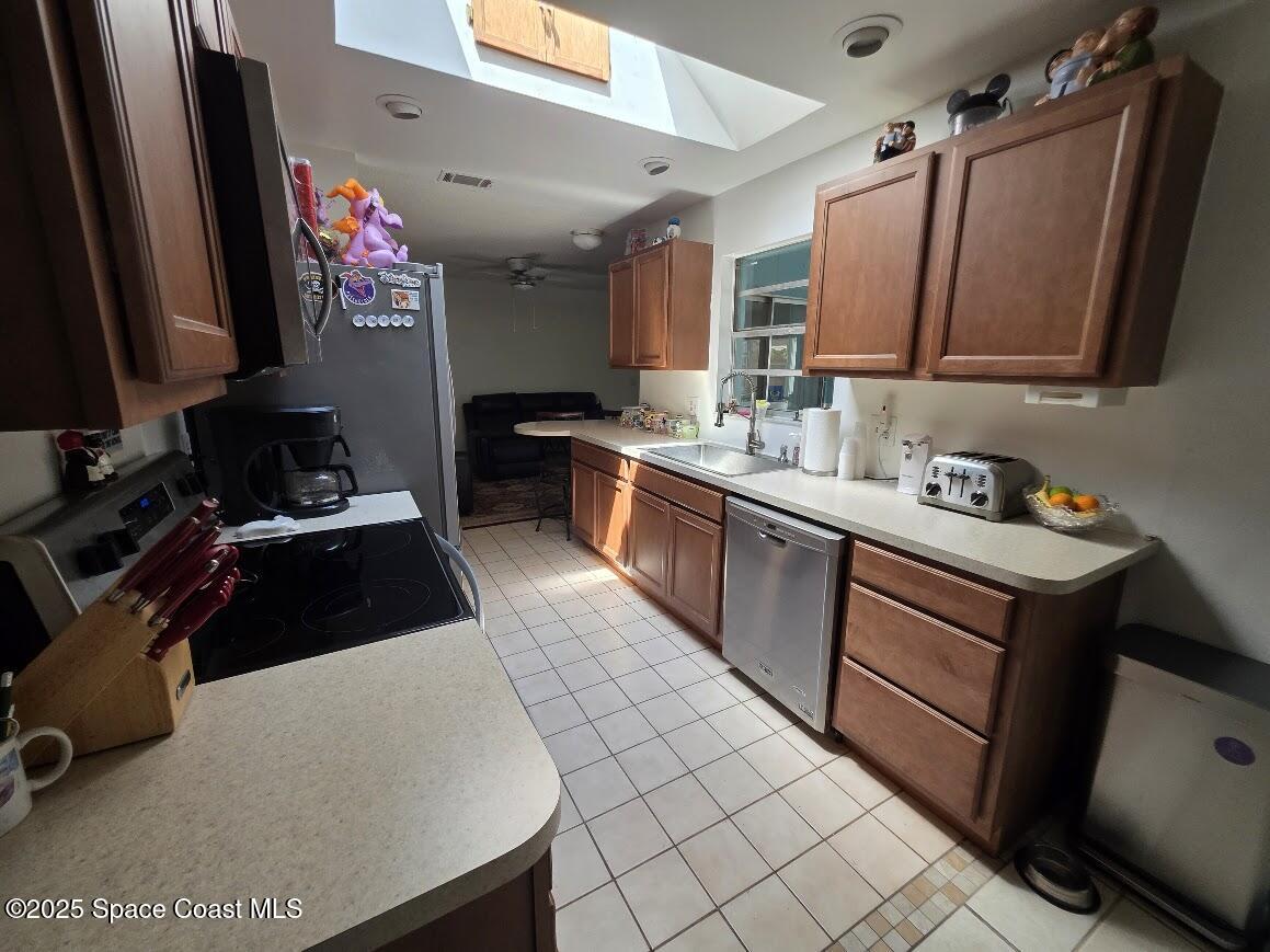 250 Perth Avenue Merritt Island, FL 32953 - Photo 7 of 48 a kitchen with a sink stove and cabinets