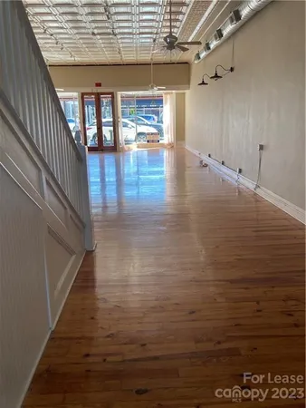 a view of a room with wooden floor