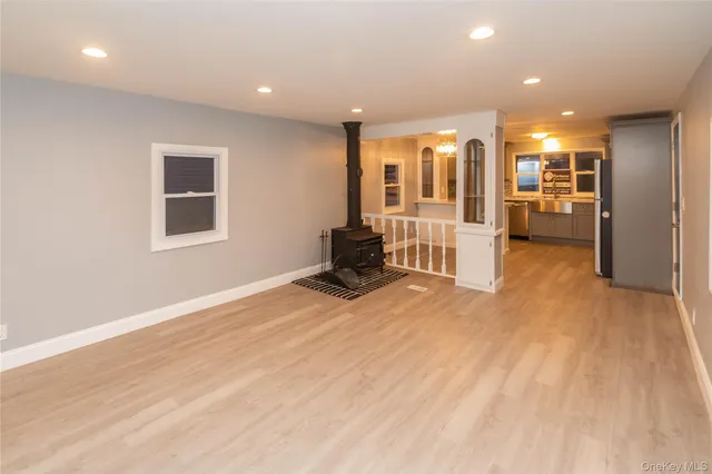 a view of a big room with wooden floor and furniture