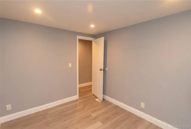 a view of a wooden deck and a yard with wooden fence