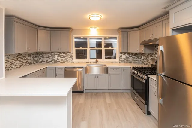 a kitchen with a sink stove and refrigerator