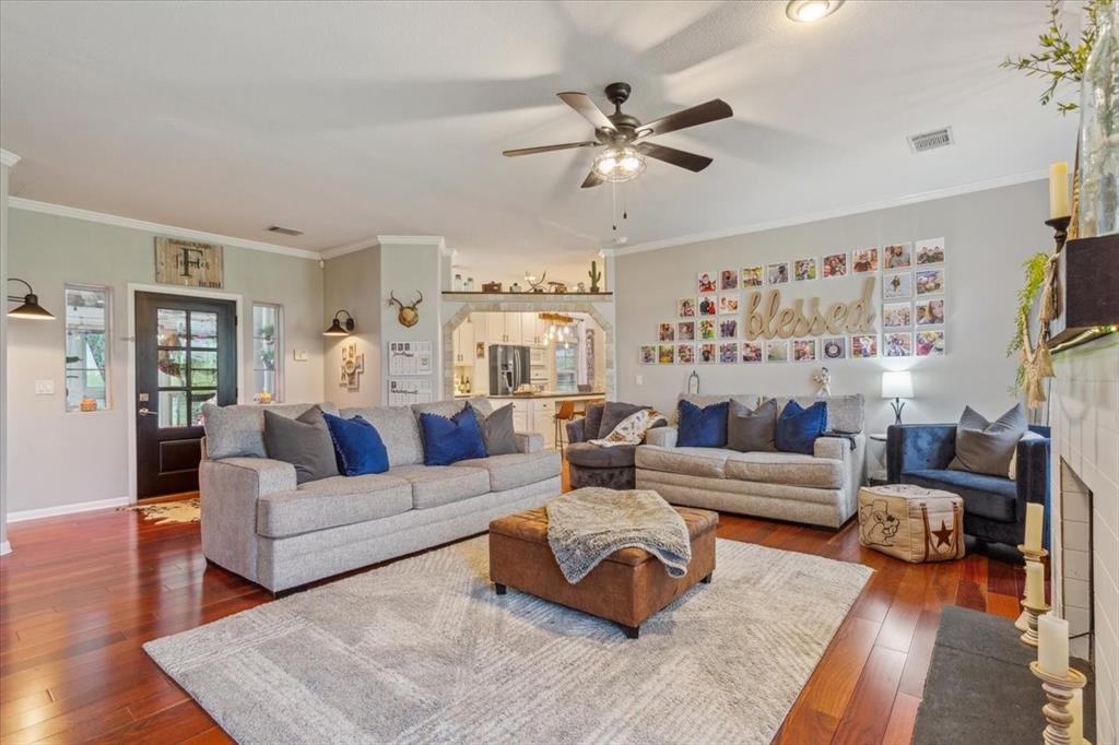 3356 Kattner Road Riesel, TX 76682 - Photo 11 of 40 Living room featuring dark wood finished floors, visible vents, and a ceiling fan