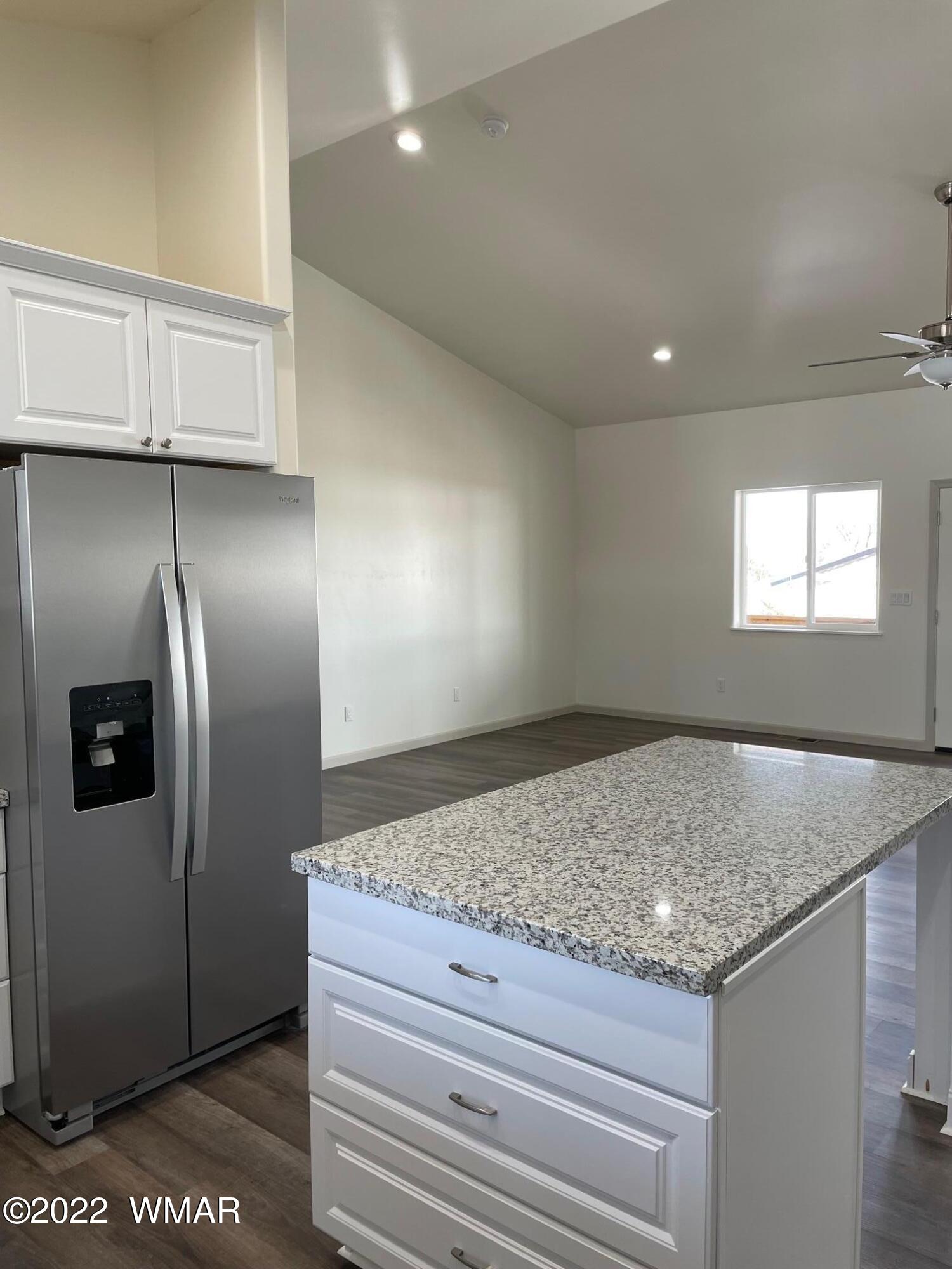 442 Susie Lane Springerville, AZ 85938 - Photo 13 of 46 a bathroom with a granite countertop sink and refrigerator