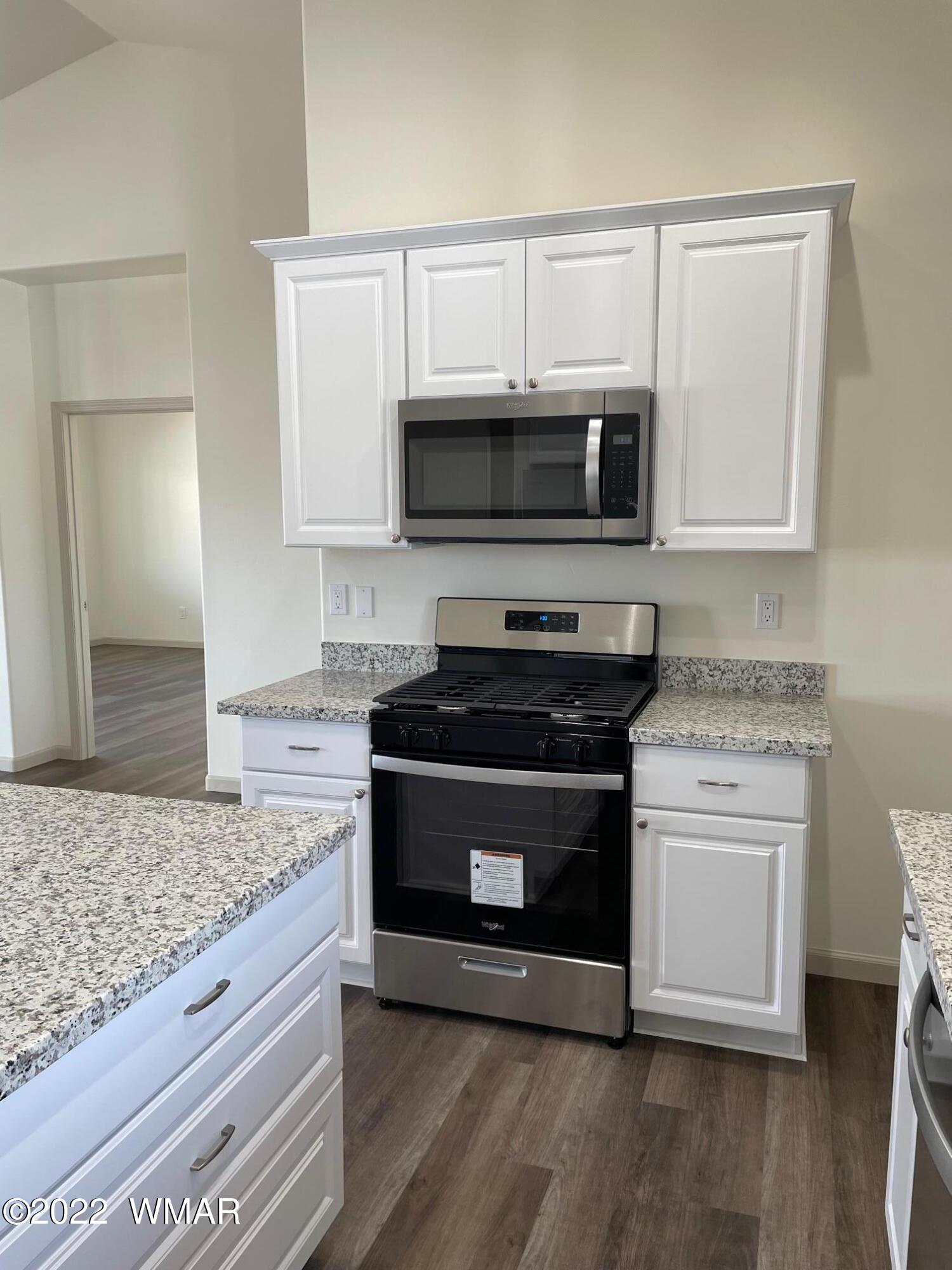 442 Susie Lane Springerville, AZ 85938 - Photo 16 of 46 a kitchen with granite countertop a stove and a microwave