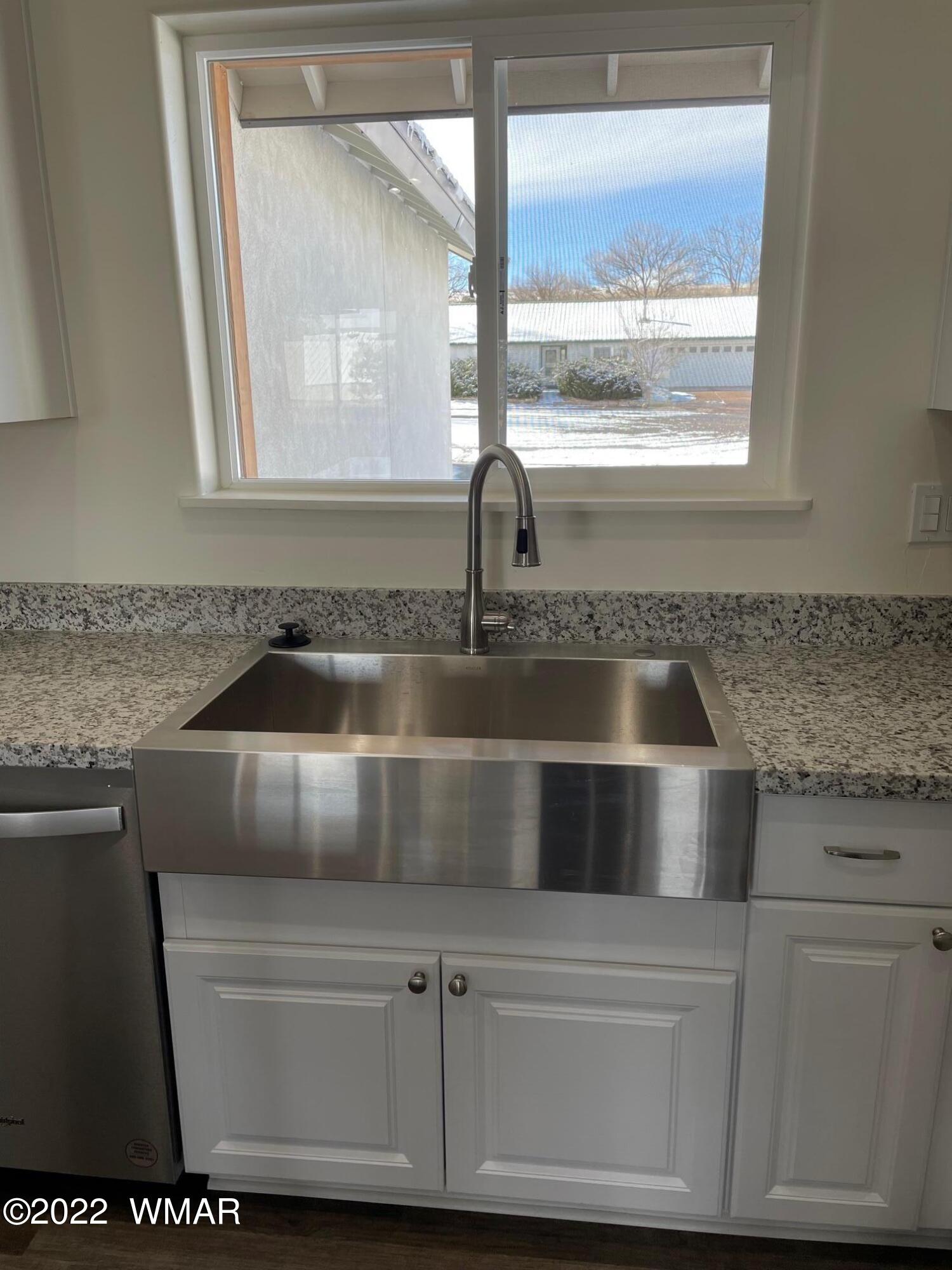 442 Susie Lane Springerville, AZ 85938 - Photo 17 of 46 a kitchen with granite countertop a sink and a window
