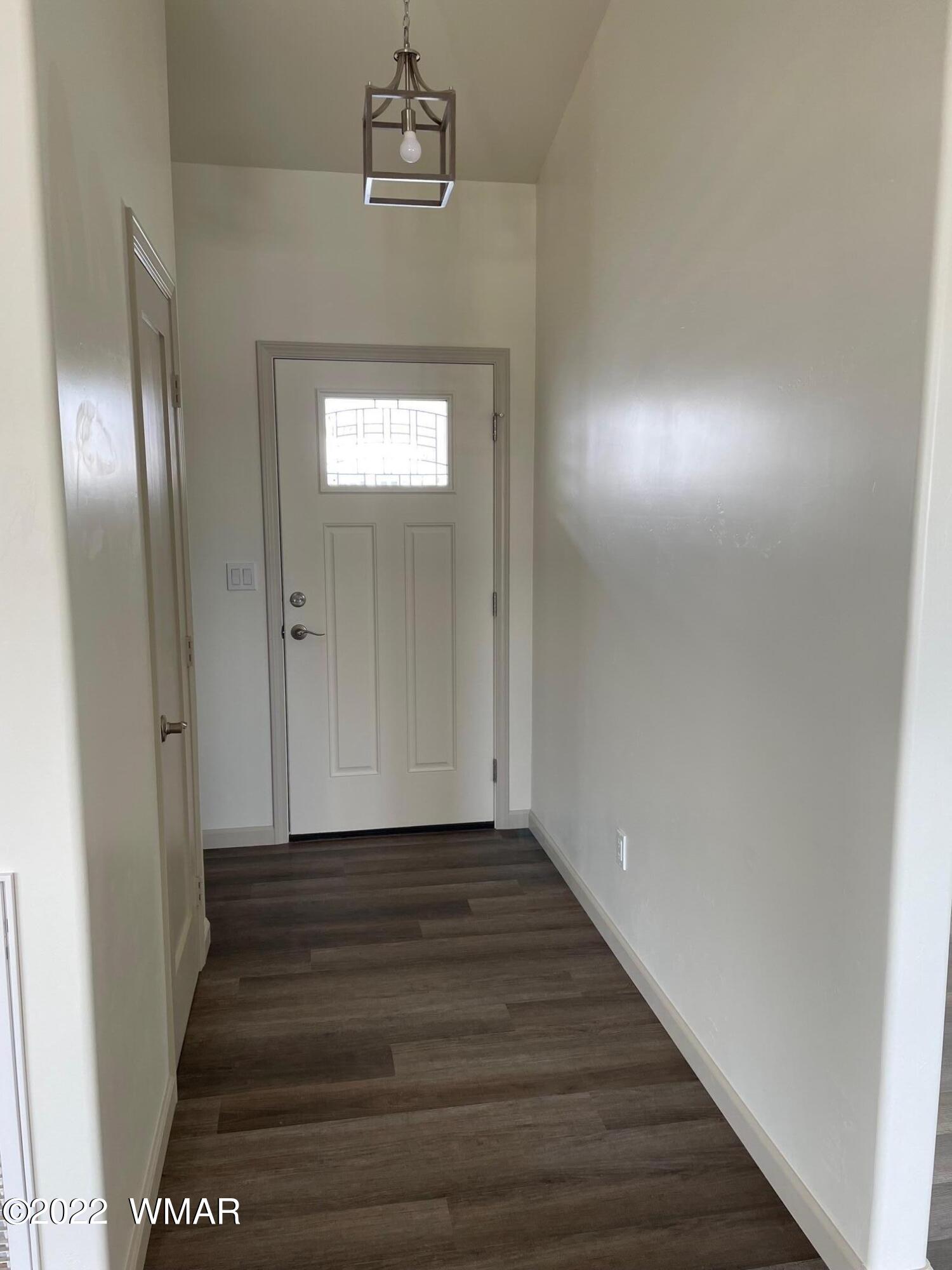 442 Susie Lane Springerville, AZ 85938 - Photo 2 of 46 a view of a hallway with wooden floor and staircase