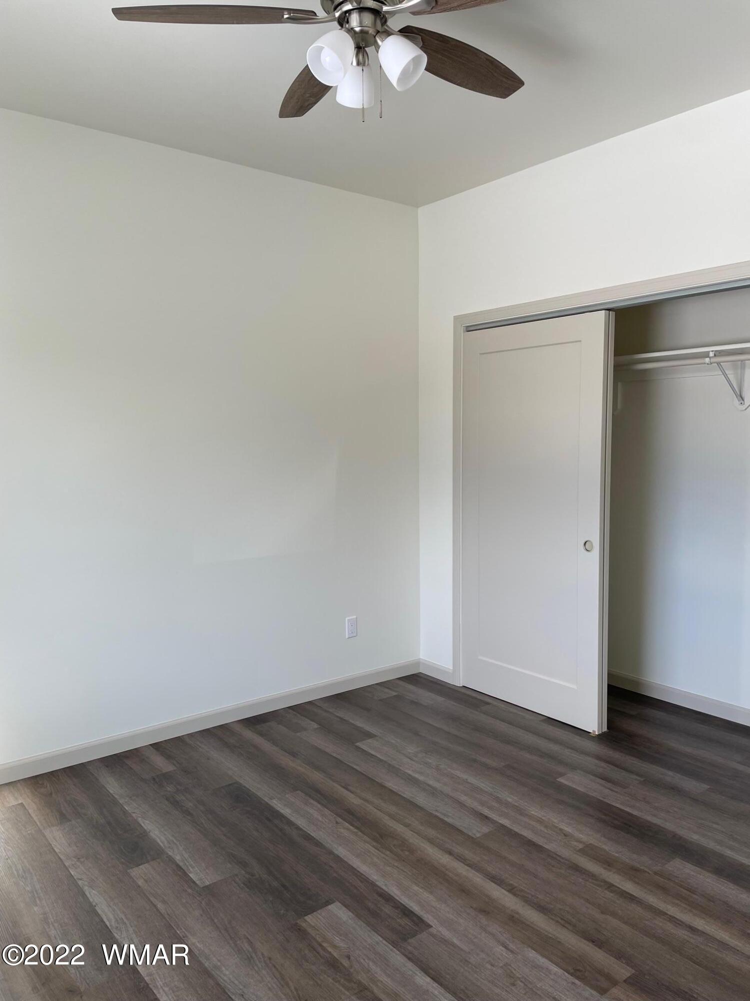 442 Susie Lane Springerville, AZ 85938 - Photo 22 of 46 an empty room with wooden floor and fan
