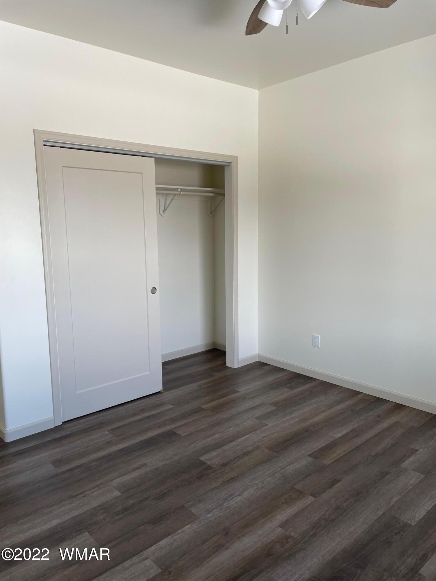 442 Susie Lane Springerville, AZ 85938 - Photo 25 of 46 an empty room with wooden floor cabinet and windows