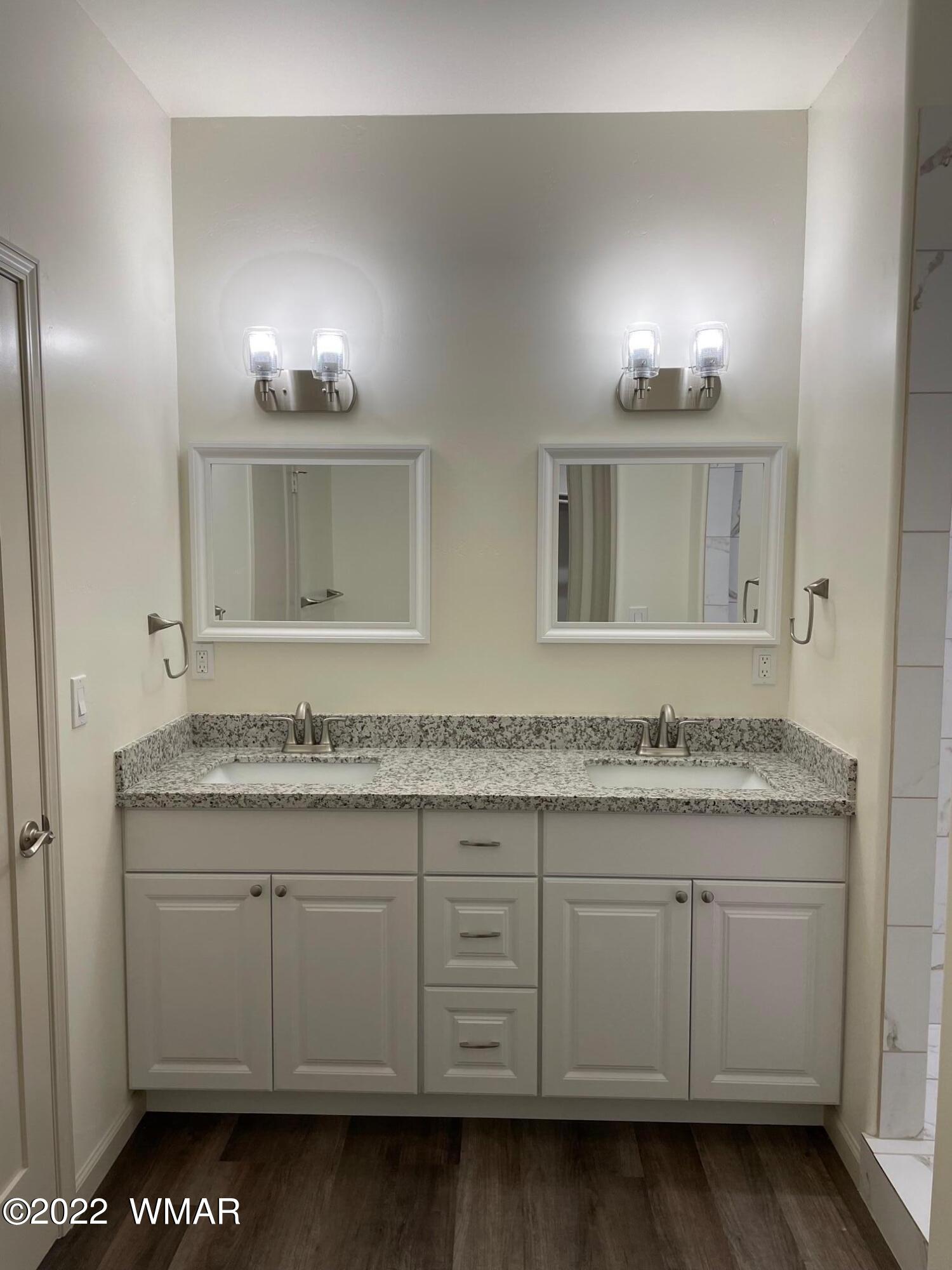 442 Susie Lane Springerville, AZ 85938 - Photo 27 of 46 a bathroom with a granite countertop sink and a mirror
