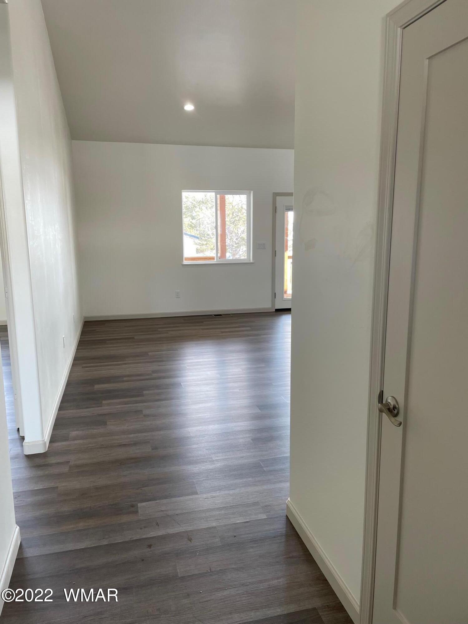 442 Susie Lane Springerville, AZ 85938 - Photo 3 of 46 a view of hallway with window and wooden floor
