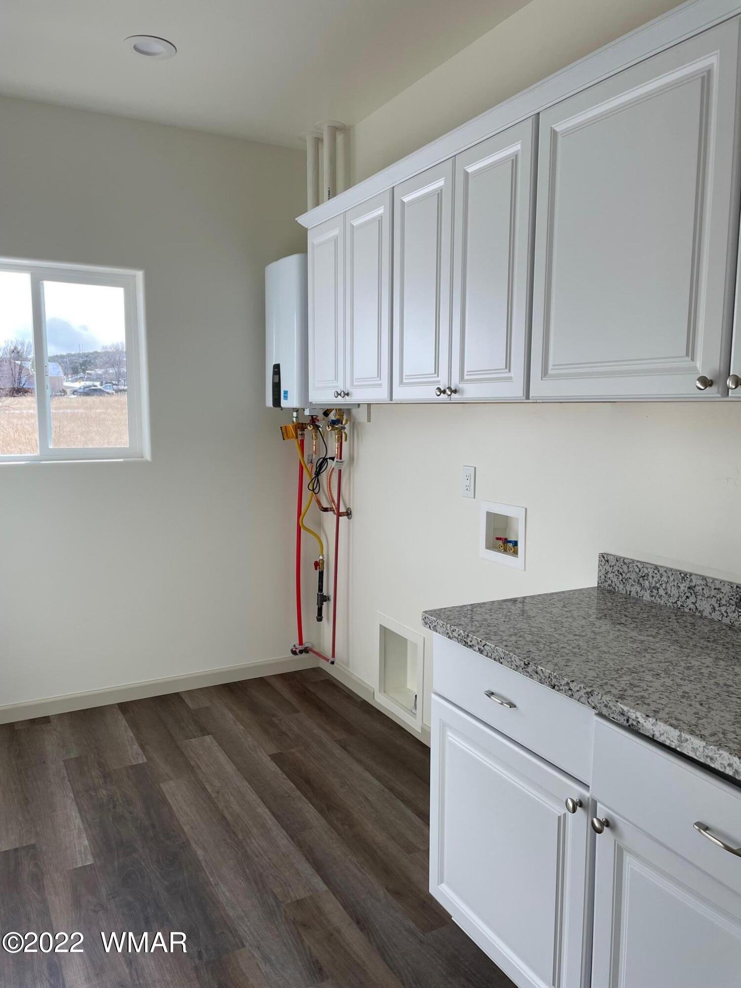 442 Susie Lane Springerville, AZ 85938 - Photo 33 of 46 a kitchen with granite countertop a sink cabinets and stainless steel appliances