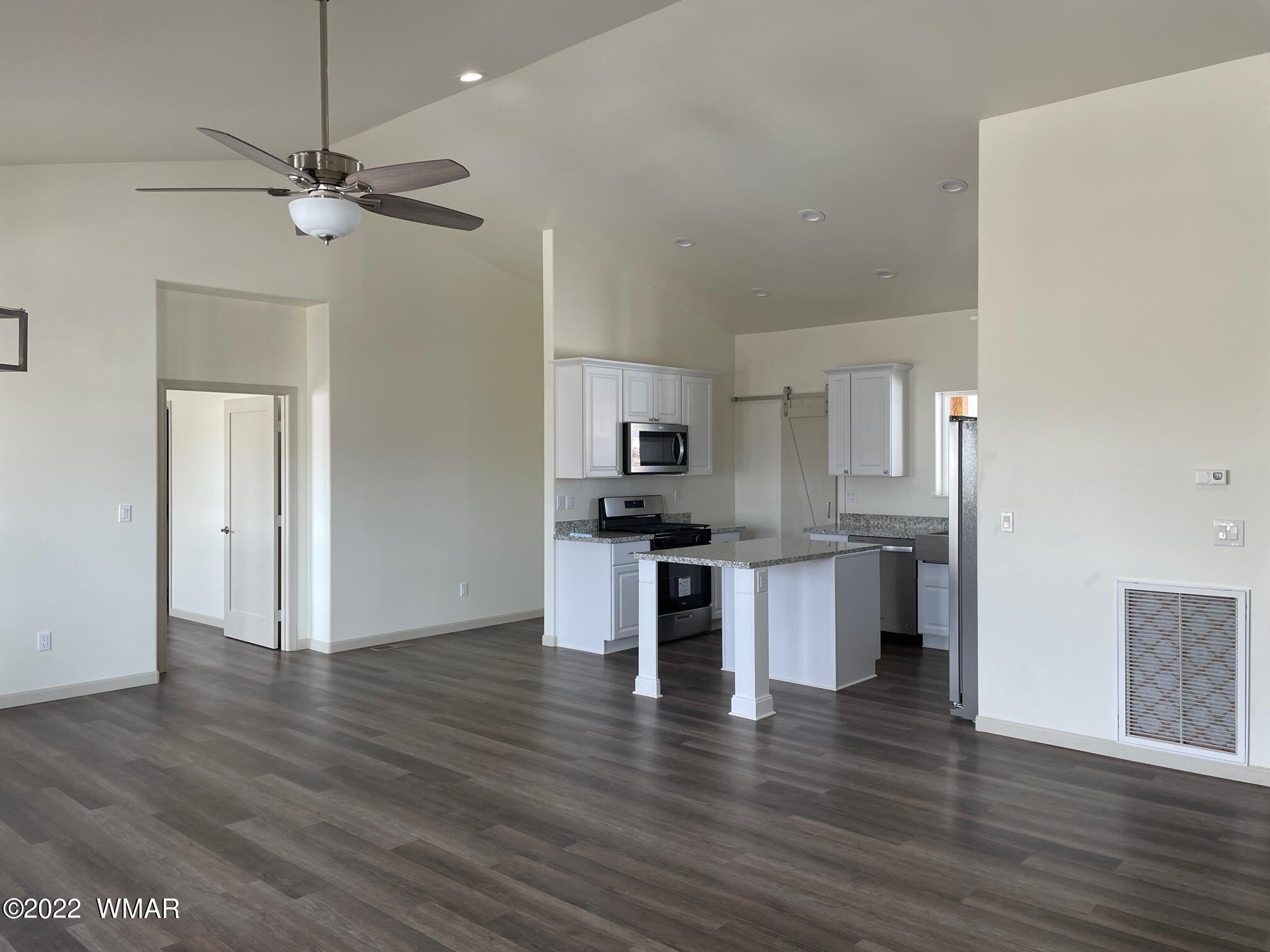 442 Susie Lane Springerville, AZ 85938 - Photo 5 of 46 a kitchen with stainless steel appliances kitchen island a refrigerator sink and stove