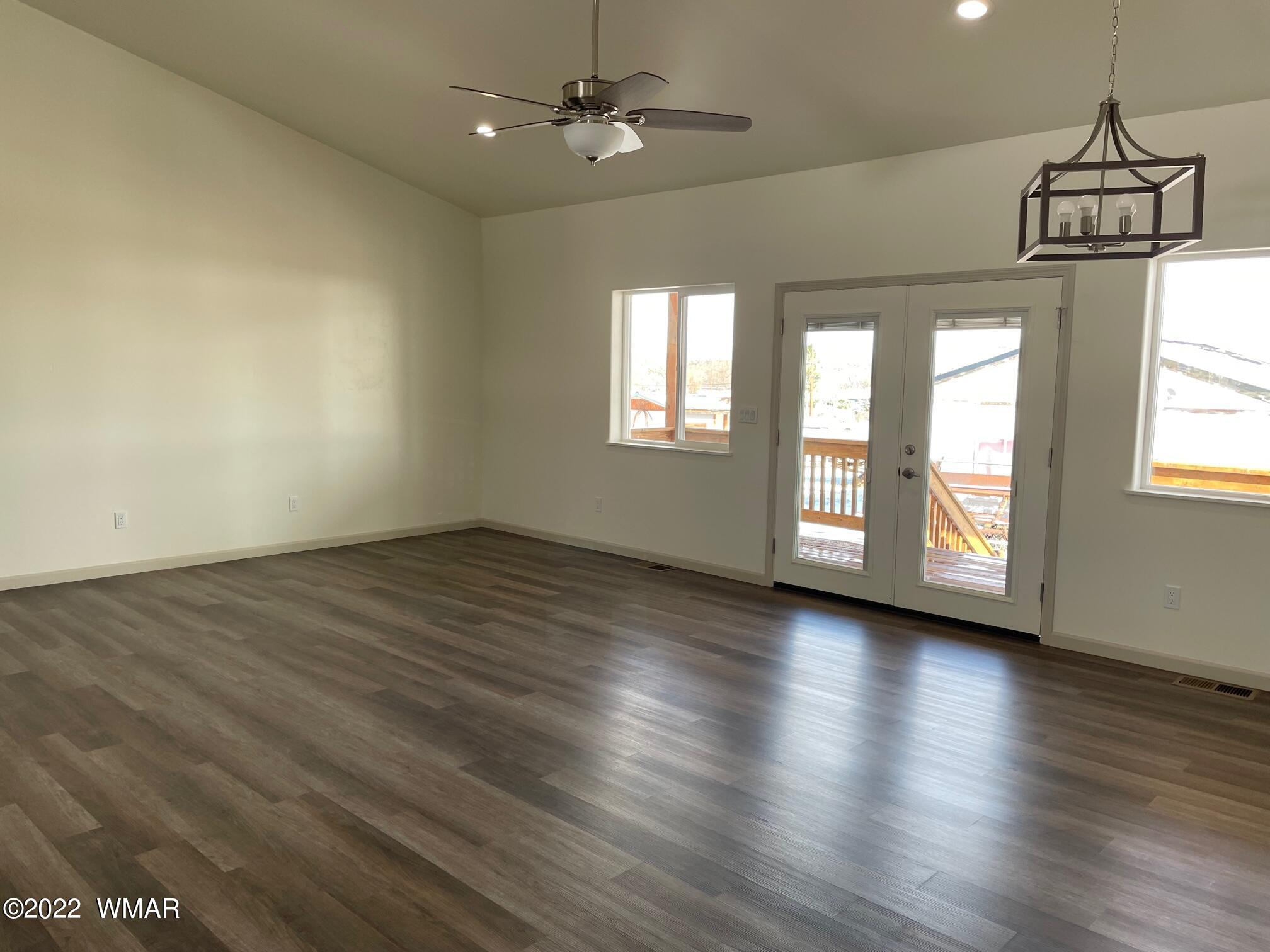 442 Susie Lane Springerville, AZ 85938 - Photo 8 of 46 an empty room with wooden floor and windows