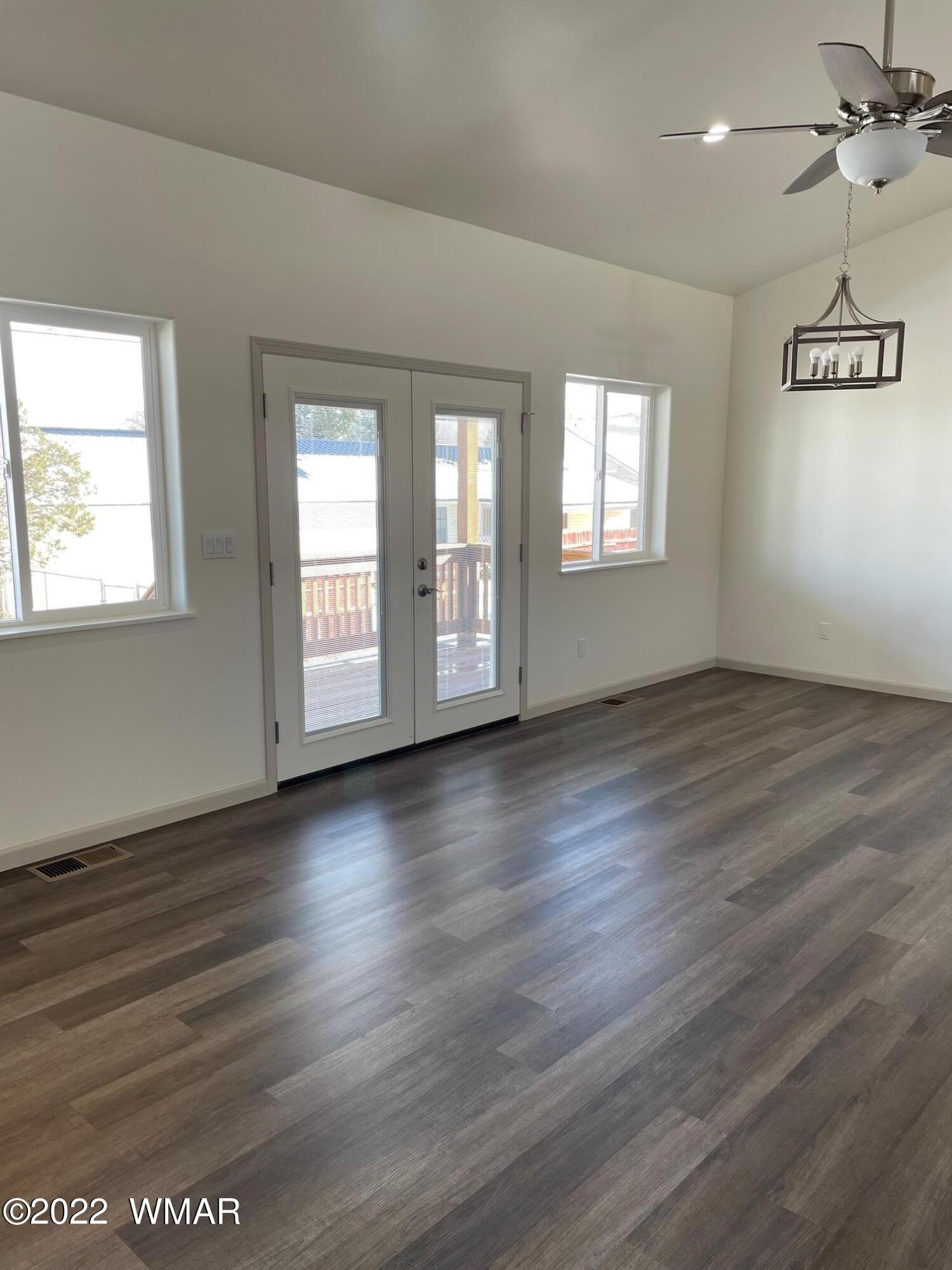 442 Susie Lane Springerville, AZ 85938 - Photo 9 of 46 an empty room with wooden floor and windows