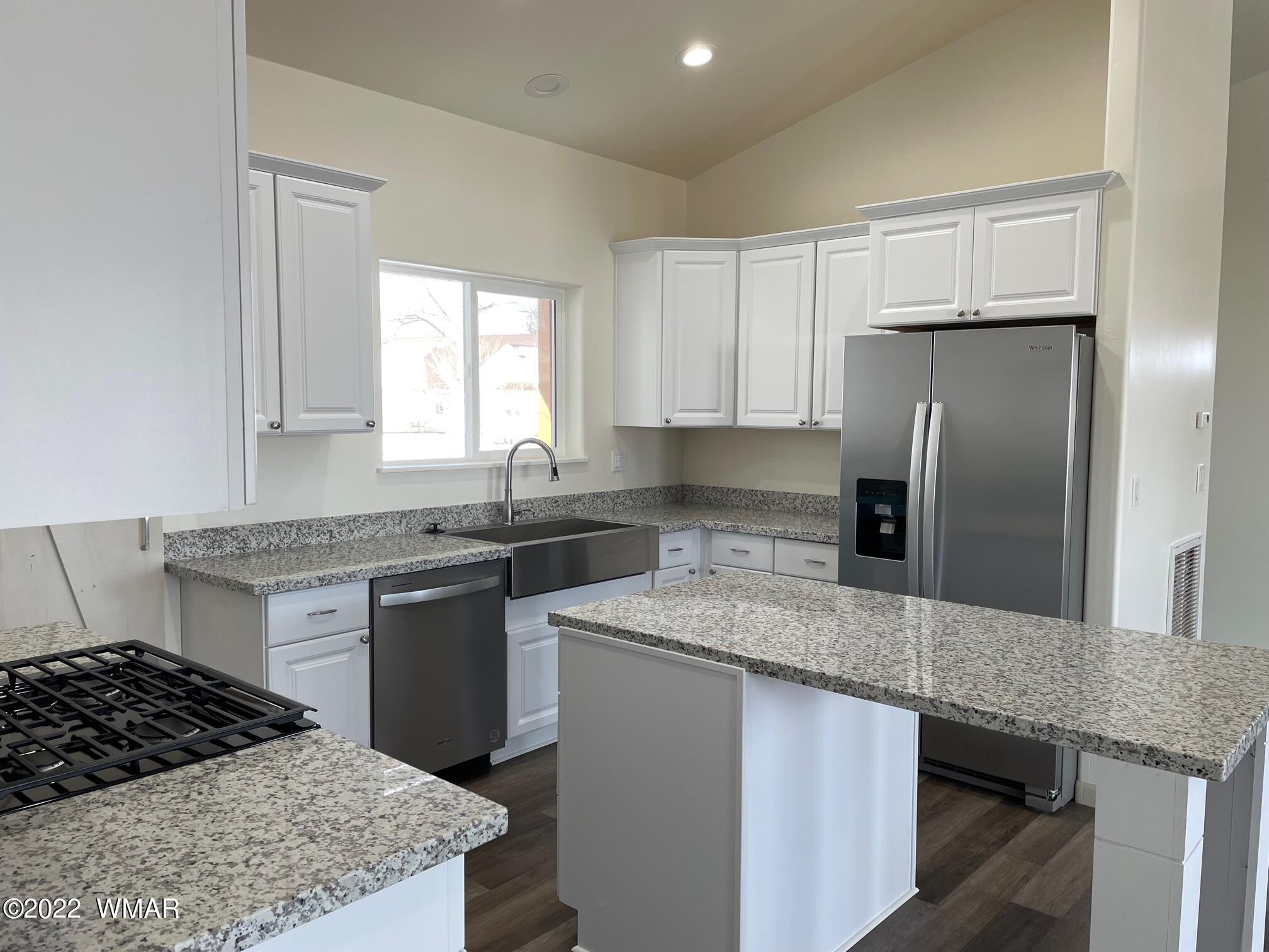 442 Susie Lane Springerville, AZ 85938 - Photo 10 of 46 a kitchen with stainless steel appliances granite countertop a sink stove and refrigerator