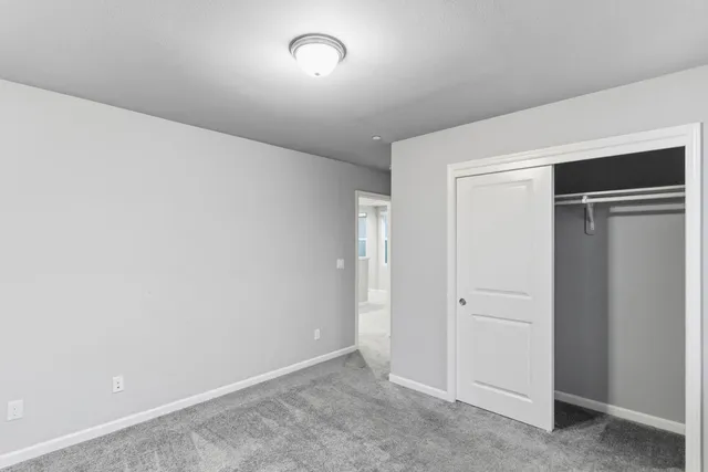 an empty room with closet area