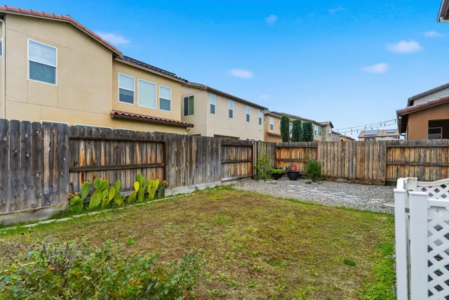 a view of a house with backyard and sitting area