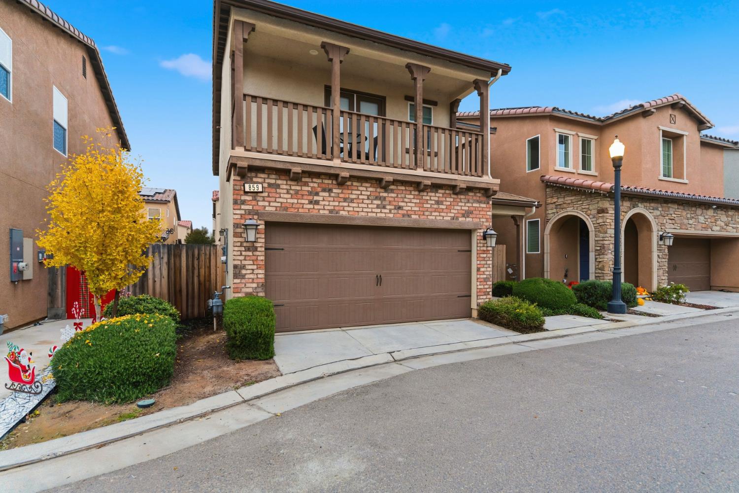 859 Lassen Lane West Madera, CA 93636 - Photo 3 of 19 a front view of a house with a yard and garage