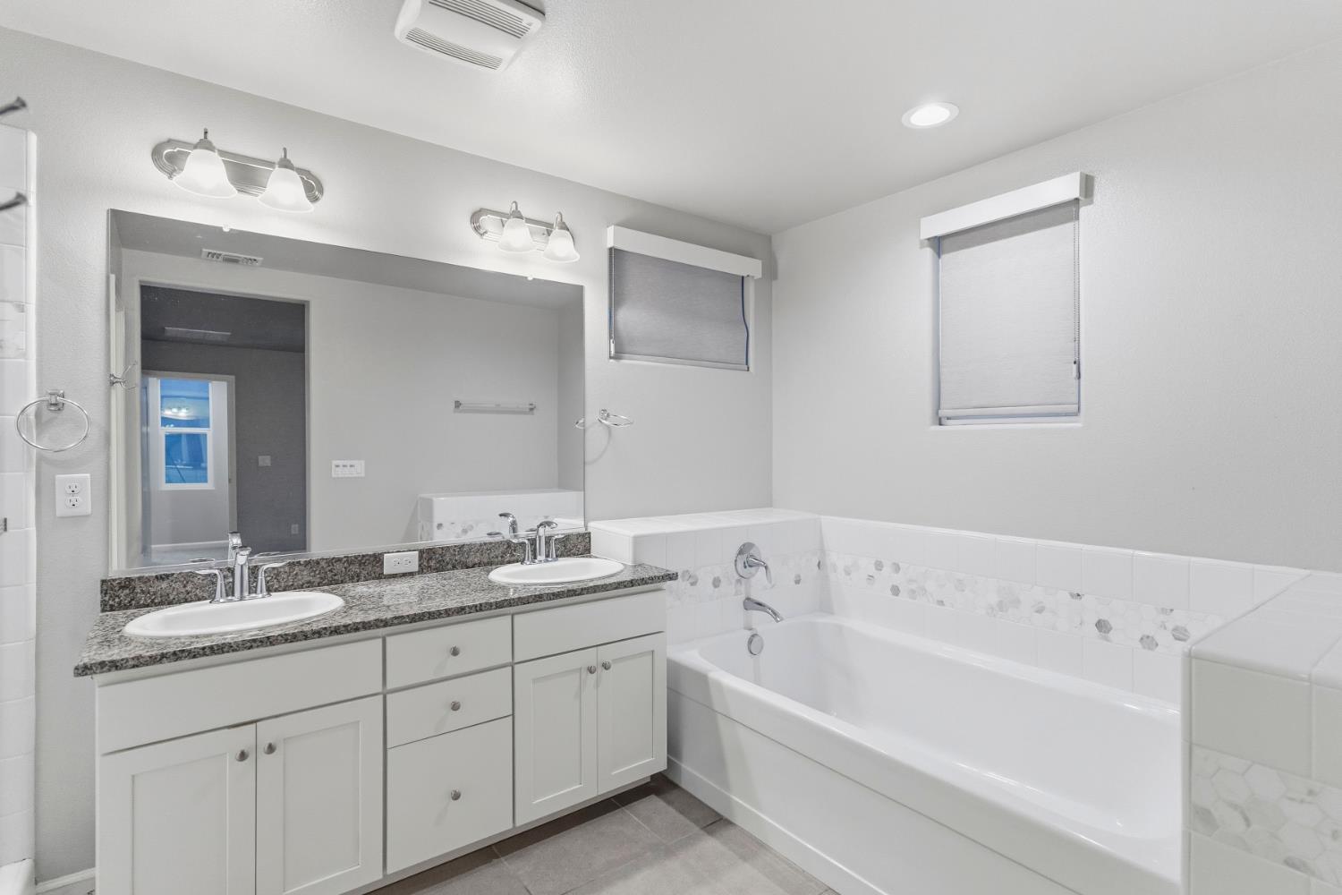 859 Lassen Lane West Madera, CA 93636 - Photo 10 of 19 a bathroom with a tub a sink and mirror