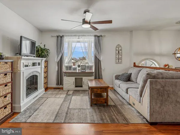 a living room with furniture a fireplace and a table