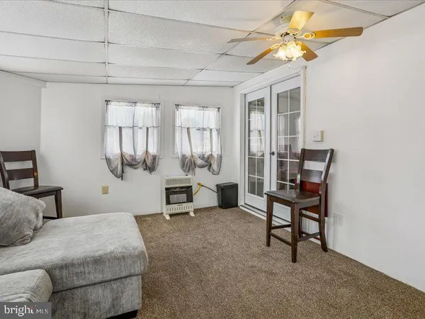 a view of living room with furniture and a window