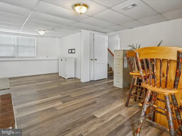 a view of a patio with table and chairs and potted plants