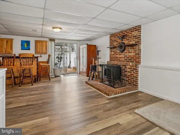a kitchen with granite countertop a sink cabinets stainless steel appliances and a window