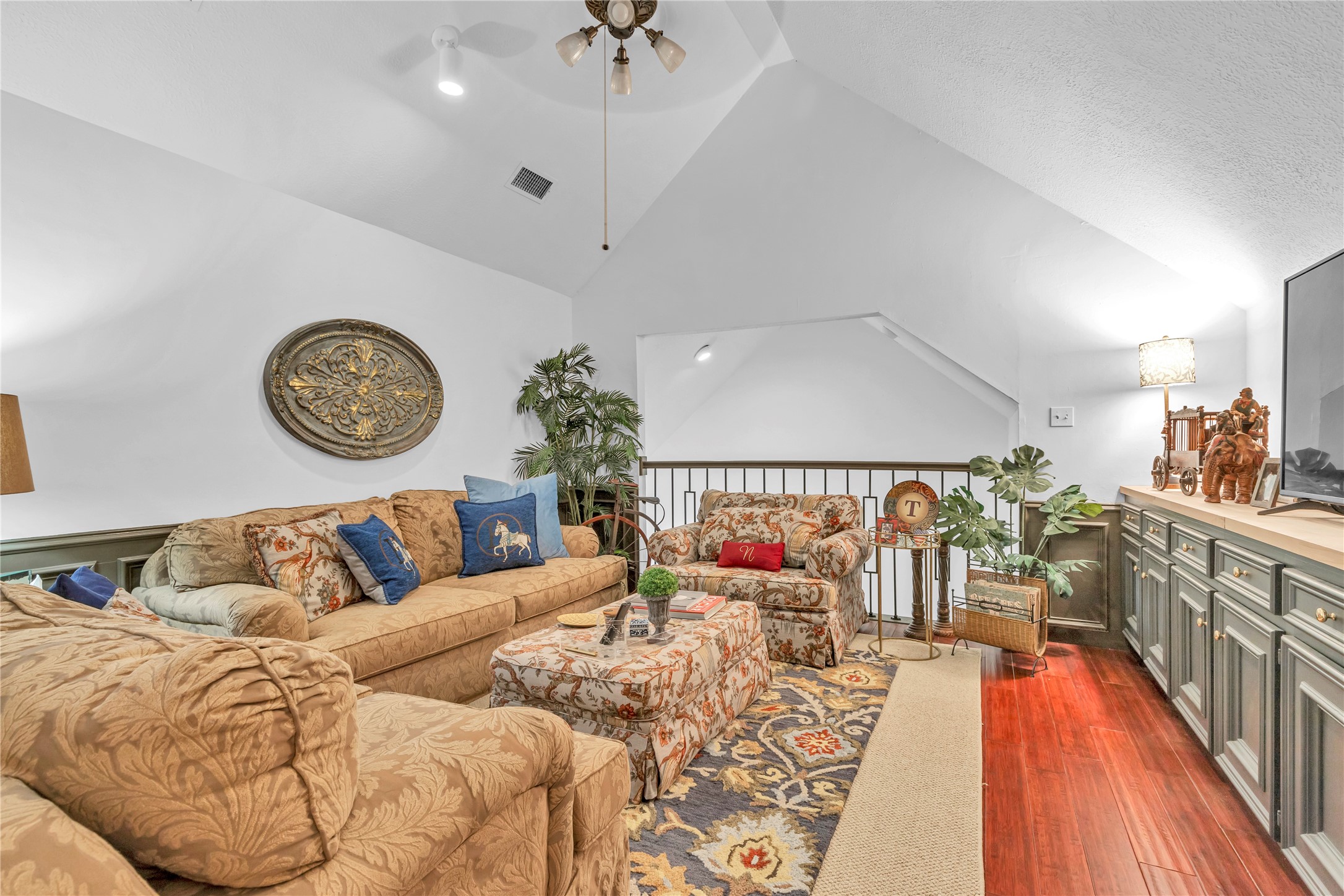 7631 Ameswood Road Houston, TX 77095 - Photo 25 of 33 a living room with furniture a rug and a chandelier